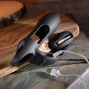 Rechargeable black silicone dual cock ring Nautilus with USB charging cable on wooden surface.