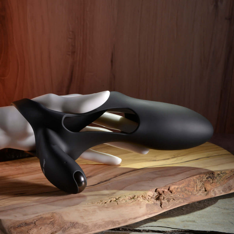 Zero Tolerance Nautilus Black Silicone Dual Cock Ring on a wooden surface for enhanced intimacy and pleasure.