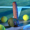 Zero Tolerance Nutty Buddy rechargeable silicone dual cock ring in green on a tennis court with balls.