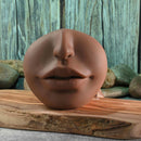 Channel Heart Movie & Realistic Kiss & Tell Stroker featuring a lifelike mouth design on a wooden surface.
