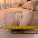 Squirt For Me XL Riley Reid Movie & Realistic Squirting Stroker displayed on a bed with measuring tape.
