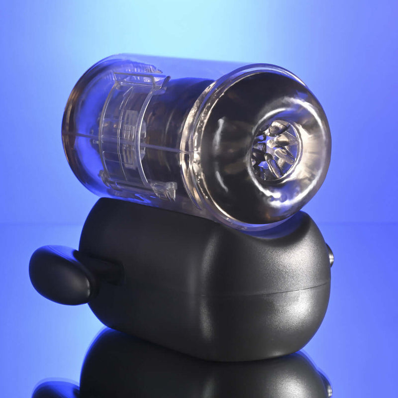 Zero Tolerance Hold Me Tight Heated Stroker Black on a reflective surface with a blue background.