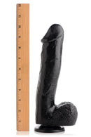 Mighty Midnight 10 Inch Black Dildo with Suction Cup next to a ruler for size reference.