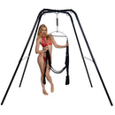 Model demonstrating the Trinity Ultimate Sex Swing Stand with black finish and secure hanging system.