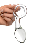 Prisms Devi Borosilicate Glass Anal Plug Clear held in hand, showcasing elegant design and curved shape for pleasure.