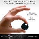 Master Series Jaded Glass Ben Wa Balls Green held in hand for thrilling temperature play.