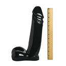 Master Cock Immense Ivan 12.5 Inch Black Dildo next to a ruler for size comparison.