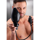 Master Series Expand XL Inflatable Anal Plug Black held by a man, showcasing its inflatable feature for enhanced pleasure.