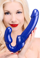 Strap U Revolver II Vibrating Strapless Strap On Dildo in blue held by a model with blonde hair and red lips.