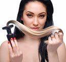 Woman holding a blonde ponytail butt plug, showcasing its silky texture and tapered design.