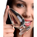 Woman holding Prisms Erotic Glass Ember Weighted Tapered Anal Plug, showcasing its smooth design and tapered tip.