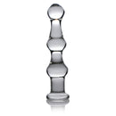 Master Series Mammoth 3 Bumps Glass Dildo Clear next to a reflective surface, showcasing its three pronounced bumps.