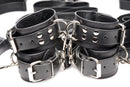 Close-up of the Strict Leather Bed Restraint Kit Black cuffs with heavy-duty hardware and leather design.