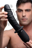 Power Pounder Vibrating and Thrusting Silicone Dildo Black held by a man, showcasing its realistic design and features.