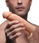 Size Matters 2 Inch Silicone Penis Extension Flesh held by a man, showcasing realistic texture and design for enhanced pleasure.