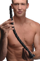 Hosed Swirled 18 Inch Thin Anal Snake Dildo Black held by a man, showcasing its curved design and texture.