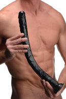 Hosed Realistic 19 Inch Anal Dildo Black held by a man, showcasing its lifelike design and detailed texture.