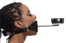 Master Series Ashtray Ball Gag Black worn by a model, featuring a silicone ball gag and metal ashtray.
