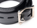 Close-up of the buckle on the Strict Leather Wrapped Spreader Bar with Cuffs Black, showcasing its refined leather and metal detailing.