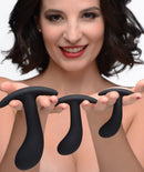 Model showcasing Dark Delights 3 Piece Curved Anal Trainer Set with three graduated silicone plugs.