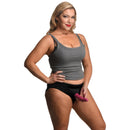 Lace Envy Black Crotchless Panty Harness 3XL on a model wearing a gray tank top and holding a strap-on dildo.