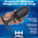 Heavy Hitters Premium Silicone Weighted Anal Plug Small held in hand, showcasing design and flexible base for comfort.