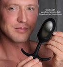 Heavy Hitters Premium Silicone Weighted Anal Plug Large held by a man showcasing its design and flexible base.