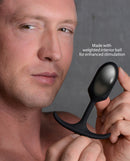 Heavy Hitters Premium Silicone Weighted Anal Plug Small held by a man, showcasing its weighted interior ball for enhanced stimulation.