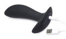 Zeus 64X Pro-Shocker Vibrating and E-stim Prostate Plug charging with USB cable, showcasing sleek silicone design.