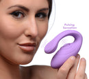 Inmi 7X Pulse Pro Clit Stimulating Vibrator Purple held by a woman, showcasing pulsing sensation features.