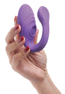 Inmi 7X Pulse Pro Clit Stimulating Vibrator Purple held in hand showcasing its ergonomic design and stimulating features.