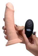 Swell 7 Inch Inflatable Vibrating Remote Control Dildo with remote in hand, showcasing its texture and design.
