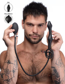 Devils Rattle Inflatable Anal Plug with Cock and Ball Ring held by a man, showcasing inflation options and silicone design.