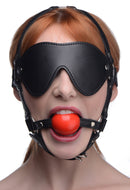 Strict Blindfold Harness and Red Ball Gag worn by a model, showcasing sensory play and submission.