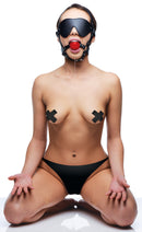 Strict Blindfold Harness and Red Ball Gag worn by a model showcasing sensory play and submission.