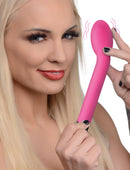 Woman holding the 10X Silicone G-Spot Vibrator Pink with a playful expression, showcasing its sleek design.
