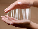Nuru Inflatable Massage Sheet Deluxe Kit showing hands holding slippery gel strands for massage.