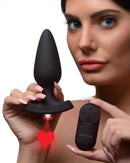 Booty Sparks 28X Laser Heart Silicone Anal Plug Large shown with remote, featuring a red laser heart light.