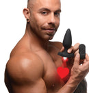 Booty Sparks 28X Laser Heart Silicone Anal Plug Large showcased with a remote, highlighting its vibrant laser heart feature.