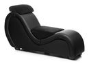 Sleek black leather chaise lounge with plush headrest and contoured design for comfort and style.