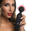 Woman holding Master Series 72X Silicone Heating Wand Massager Black with a glowing heat indication and digital display.