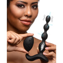 Zeus Shock-Beads 80X Vibrating E-stim Silicone Anal Beads held by a woman with remote control.