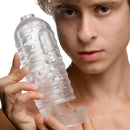 LoveBotz Milker Masturbator with Ball Strap Clear held by a model, showcasing its soft and stretchy design.