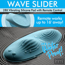 28X Wave Slider Vibrating Silicone Pad with Remote on water surface with raindrops, showcasing its waterproof features.