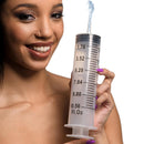 CleanStream Enema Syringe with Tube 300ml Clear held by a smiling person, showcasing clear measurement markings.