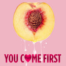Slice of peach with drips, featuring text 'YOU COME FIRST' in bold letters on pink background.