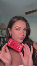 Eye of Love Matchmaker Crimson Kiss Pheromone Lip Gloss displayed by a model in a bright setting.