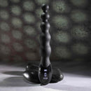 Flexible beaded vibrator with 9 speeds for intense backdoor play by ZERO TOLERANCE, displayed on smooth stones.