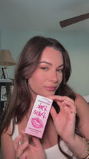 Eye of Love Matchmaker Pink Pulse Pheromone pH Lip Stain in a woman's hands, showcasing the lipstick box.