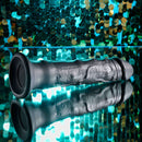 Evolved Black Thunder internal massager with beads, remote control, and suction cup base against decorative background